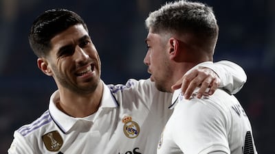 Real Madrid's Fede Valverde, right celebrates with his teammate Marco Asensio after scoring to give his side the lead against Osasuna. AFP
