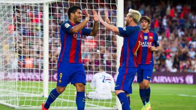 Luis Suarez, left, of Barcelona celebrates with his teammate Lionel Messi after scoring the opening goal during the Joan Gamper trophy match between Barcelona and UC Sampdoria in August. Alex Caparros / Getty Images