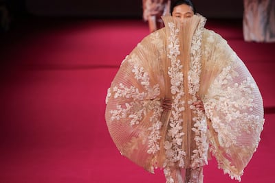 Malhotra teases fabric into a protective cocoon, reminiscent of a mother's embrace. AFP