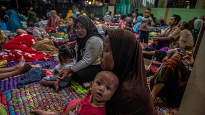 People take shelter in a community hall in Candipuro village, East Java. AFP