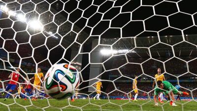 The ball enters the net as Jorge Valdivia, unseen, scores Chile's second goal against Australia on Friday night in their 3-1 win at the 2014 World Cup in Cuiaba, Brazil. Matthew Lewis / Getty Images