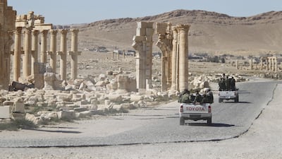 Syrian army soldiers drive past the Arch of Triumph in the historic city of Palmyra, in Homs Governorate. Reuters, file