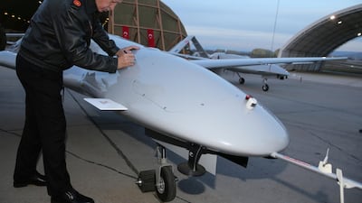 Turkey's President Recep Tayyip Erdogan signs a drone at a military airbase in Batman, Turkey. Murat Cetinmuhurdar/ AP)