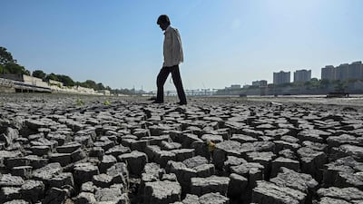 A man walks on the dry riverbed of the Sabarmati River in Ahmedabad earlier this year. AFP