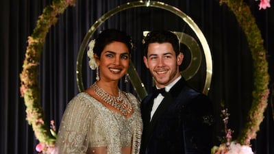Newlyweds Priyanka Chopra, 36, and Nick Jonas, 26, pose for a photograph during a reception at a hotel in New Delhi on December 4, 2018. Photo: AFP