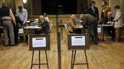 Voters show their identification before casting their votes at a polling in Tulle central France on April 23, 2017, after a campaign clouded by security fears following a recent attack on police guarding the Champs-Elysees in Paris. Bob Edme/ AP Photo