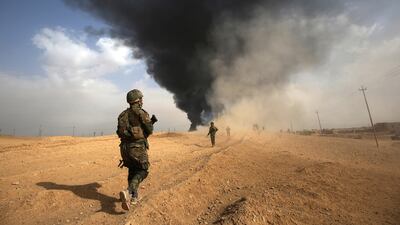Iraqi forces and members of the Popular Mobilisation units advance towards Al Qaim, in Iraq's western Anbar province near the Syrian border. AFP