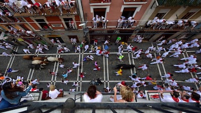 Revellers are seen from above, running next to the bulls. Alvaro Barrientos / AP Photo