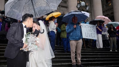 Newly-weds juxtaposed against a protest by doctors and members of the Victorian branch of the Australian Medical Association outside Parliament House in Melbourne. AFP