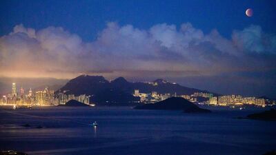 The total lunar eclipse was visible above Hong Kong. The Moon appeared slightly reddish in colour. AFP