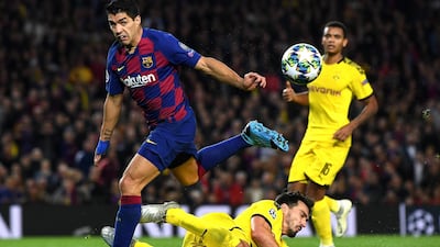 Barcelona's Luis Suarez is tackled by Mats Hummels of Dortmund. Getty