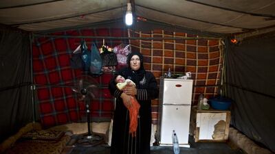 Huda Alhumaidi, 30, holds her daughter Islam, 4 weeks old.