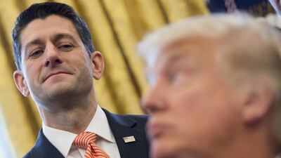 US President Donald Trump speaks to Speaker of the House Paul Ryan after signing House Joint Resolution 41 in the Oval Office of the White House in Washington DC. Saul Loeb / AFP Photo