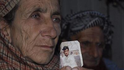 Makhni Begum holds a photograph of her son Shafqat Hussain who who was sentenced to death. The Pakistani death row prisoner whose family says he was 14 when he was convicted has been given a reprieve. M.D. Mughal / Ap Photo