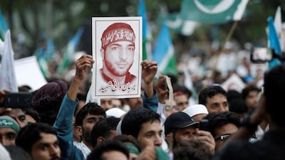 A picture of Hizbul Mujahideen commander Burhan Wani being held up during a rally in Islamabad condemning the violence in Kashmir on July 24, 2016. Caren Firouz / Reuters