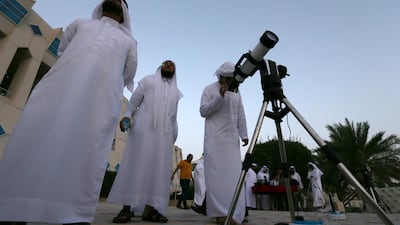 Men gather to sight the new crescent moon atop of Jebel Hafeet in Al Ain. EPA