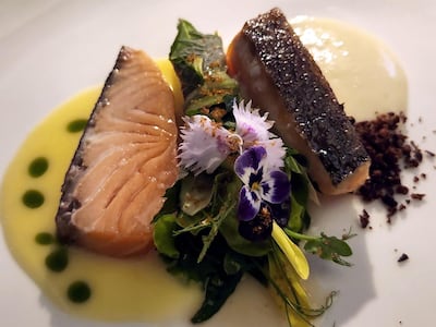 The salmon is served alongside a bouquet of herbs wrapped in a Perilla leaf – a common ingredient in Korean cuisine. Photo: Juman Jarallah / The National