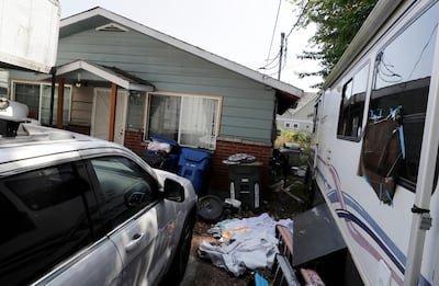 Vehicles are parked outside the home of Paige A Thompson, who uses the online handle 'erratic'. Ms Thompson was arrested late last month and has been charged with a single count of computer fraud and abuse in US District Court in Seattle. AP