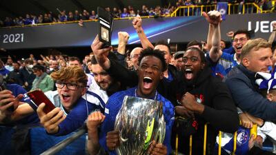 Callum Hudson-Odoi of Chelsea celebrates with the Uefa Super Cup with Chelsea fans.