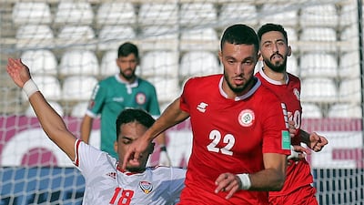 UAE's midfielder Abdullah Ramadan challenges Bassel Jradi of Lebanon. AFP