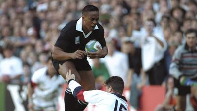 All Blacks great Jonah Lomu charges through the tackle of England's Mike Catt to score one of his four tries during the Rugby World Cup semi-final in Cape Town in 1995. Getty