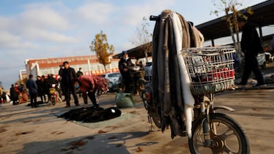 Mink furs hang from a scooter at an open air market in Li county, Hebei province, China. Reuters