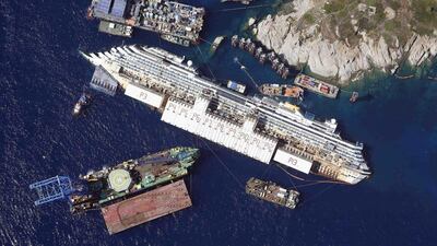 The Costa Concordia lies on its side next to Giglio Island before being rolled off the seabed and onto underwater platforms. Alessandro Bianchi / Reuters