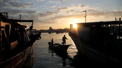The sun rises as fishermen are seen at the seaport of Gaza City. Reuters