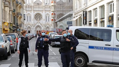 French policemen stand guard in the street leading to the church. AFP