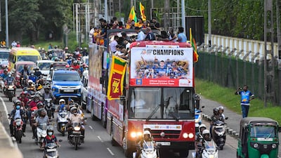 Members of the Sri Lankan team travel on an open-top bus in Colombo on Tuesday, September 13, 2022, to celebrate their victory in the Asia Cup T20 tournament in UAE. AFP