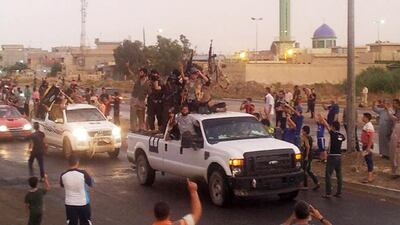 Parading ISIL fighters being applauded in Mosul, Iraq, in June 2014, shortly after taking control of that strategically important city. AP Photo
