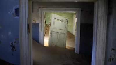 Sand fills an abandoned house in Kolmanskop, Namibia. Kolmanskop, was a diamond mining town south of Namibia, build in 1908 and deserted in 1956. Jerome Delay / AP Photo