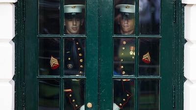 US marines prepare to open a door for the arrival of President Donald Trump. AFP