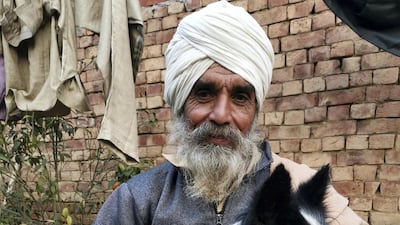 Balbir Singh plays with his dog, Jacky, after more than six weeks away from home.