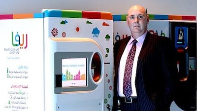 John Irvine, the managing director of averda, with ReVa, a reverse vending machine. Satish Kumar / The National
