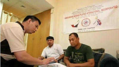 Ibrahim Robel Beltran, Ray Ian Libres and Roy Silvano, members of Sangguniang Masang Pilipino International, during a meeting in Dubai.