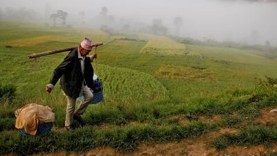 A man carries goods on his way to a temple during the Shikali festival at Khokana village in Lalitpur, Nepal. Reuters