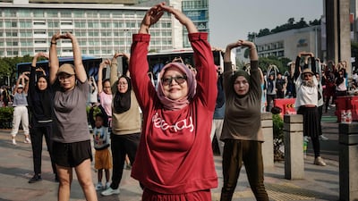 People attend a morning dance session on the street during a car-free day in Jakarta. AFP