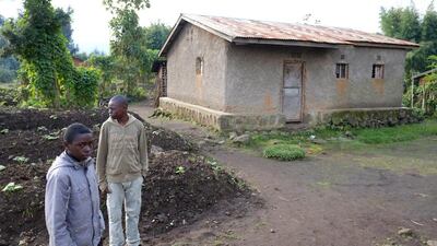 Rwandan villagers in the foothills of the Virunga Mountains. Poverty has been lifted by a series of eco-tourism projects in the region, giving local people an alternative to poaching as a way of earning a living. Courtesy Phil Sands for The National