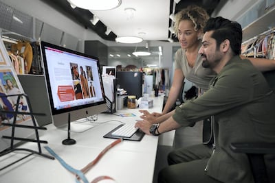 Tyler Simpson (left) and Vikas Shukla (right),work on designs at Landmark's headquarters in Dubai Marina. Pawan Singh/The National