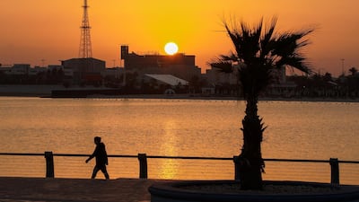 A winter stroll as the sun rises in Abu Dhabi's Corniche. Victor Besa / The National