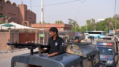Pakistani policemen lead a security convoy to protect the Zimbabwe cricket team outside the Gaddafi Cricket Stadium in Lahore on Tuesday. Aamir Qureshi / AFP