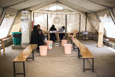 MSF aid workers in the triage room checking if patients have cholera symptoms. Al Thawra hospital.
