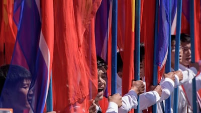Students march past a balcony from where North Korea's leader Kim Jong Un was watching, during a mass rally on Kim Il Sung square in Pyongyang. AFP