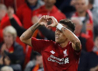 Liverpool's Roberto Firmino celebrates scoring their third and winning goal at Anfield. Reuters