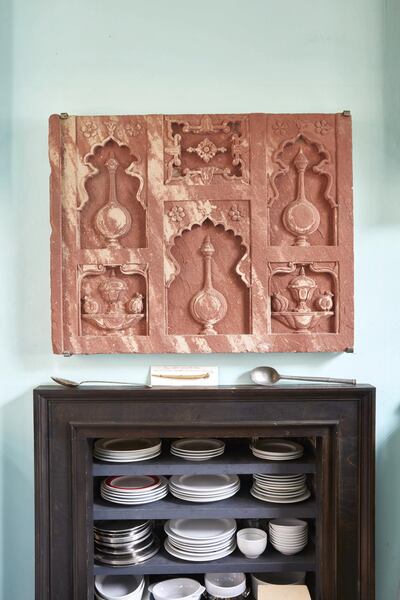 Hodgkin's carefully displayed collection of antique procelain and a Mughal Chini Kana Panel from Agra, circa 1620. A Chini Khana was an architectural element often used in Mughal garden design comprising a series of sandstone walls such as the present example which were carved with recessed niches of varied forms on which oil lamps or floral vases could be placed. The term ‘Chini Khana’ itself can be translated as ‘China Cabinet’. Sotheby's