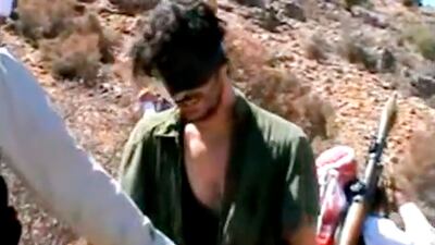 Austin Tice, who had been reporting for American news outlets in Syria until his disappearance in August 2012, prays in Arabic and English while blindfolded in the presence of gunmen. AP