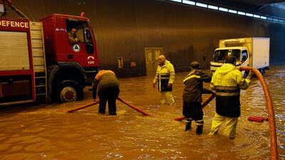 Civil Defense workers pump water out of a tunnel in Beirut's southern suburb of Ouzai. AP Photo