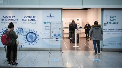 Travellers wait at a Covid-19 test centre at the airport in Munich. EPA
