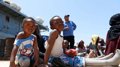 Migrants sit at a naval base after being rescued by Libyan coast guards in Tripoli last month. Almost a million people fleeing famine and warfare have made their way through hazards to reach Libya. Reuters